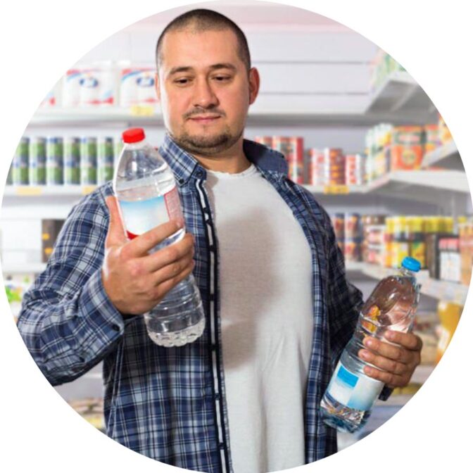 man in grocery store deciding between two water bottles